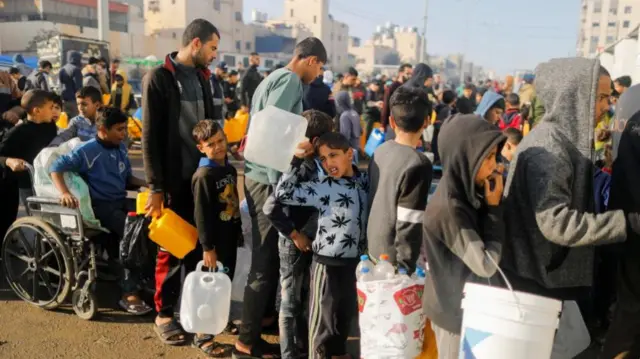 People queue for water in Rafah in southern Gaza