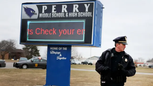 A cop outside the school