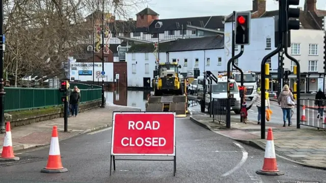 Workmen cleaning road