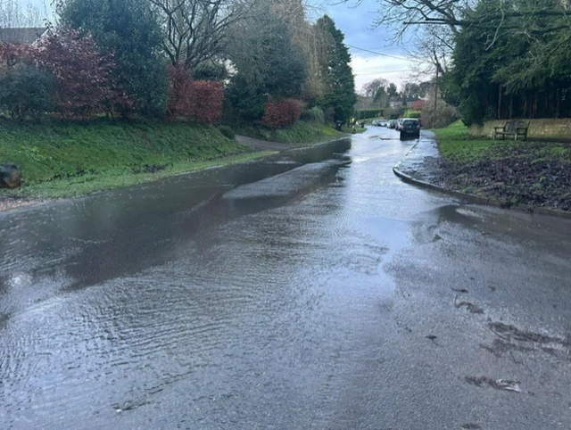 A floodded Lottage Road, Aldbourne, Wiltshire.