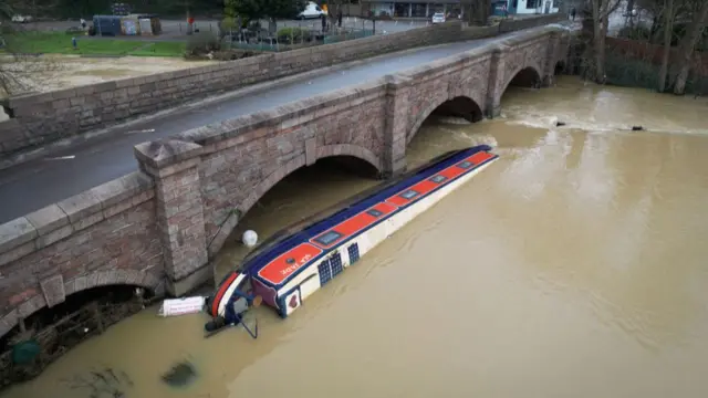 A narrowboat swept away by water in the River Soar in Leicestershire