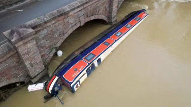 A narrowboat swept away by water in the River Soar in Leicestershire