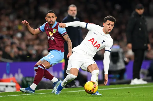 Johnson runs after a loose ball with a Burnley player in pursuit.