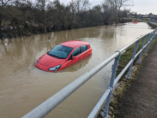 A car stranded in floodwater in Harold, Bedfordshire