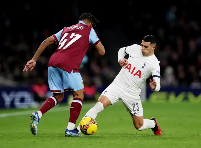 Porro presses high and challenges Odobert for the ball.