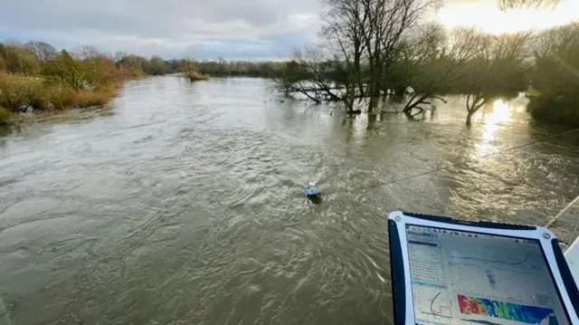 Man monitoring the River Severn with a tablet