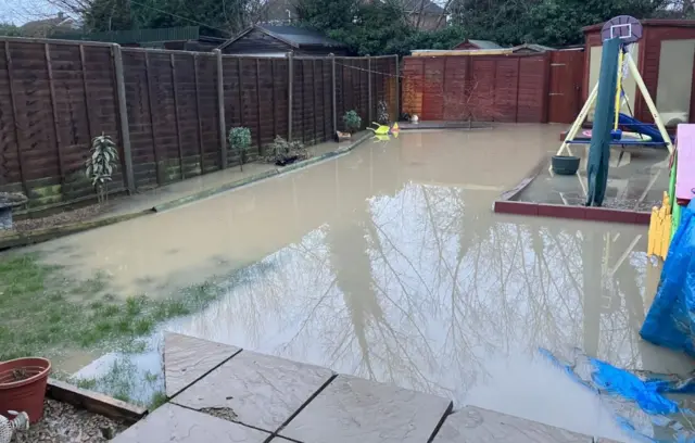 Anthony Molloy's flooded garden. The grass and play equipment submerged.