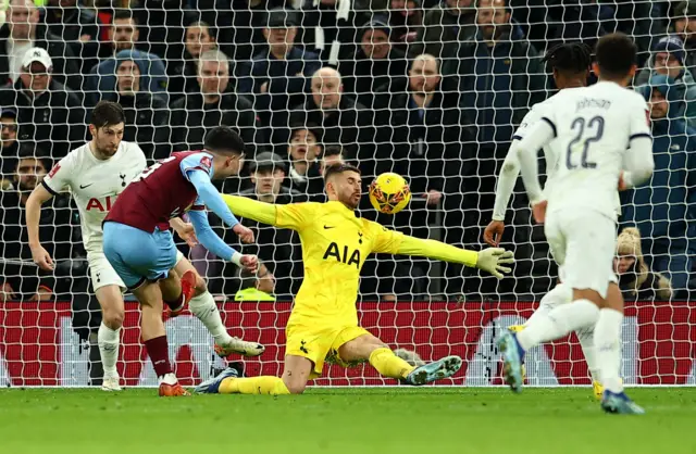 Amdouni fires at goal as Vicario spreads his body to block it.