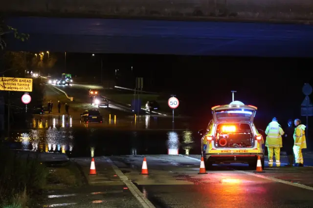 Cars stranded in flood water under the M27