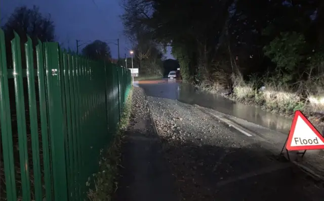 A van making his way through a flooded road