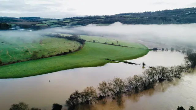 Wide shots of Lydbrook looking flooded with clouds in the middle of the shot