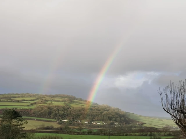 A rainbow over a valley.