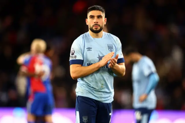 Neal Maupay claps the away fans after defeat at Palace.