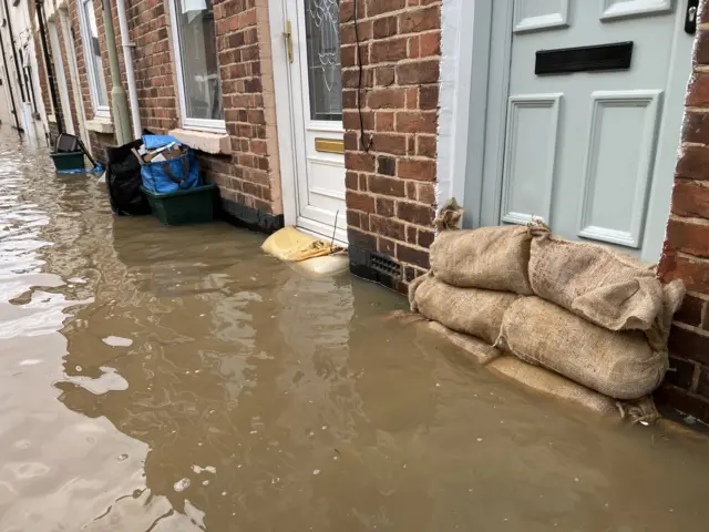 Sandbags in front of doors in Alney Island, Gloucestershire