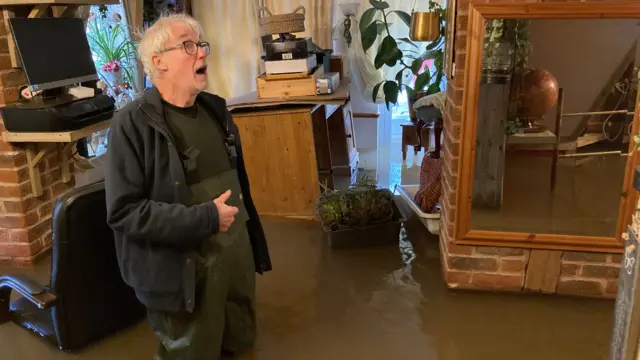 Terry in his flooded home