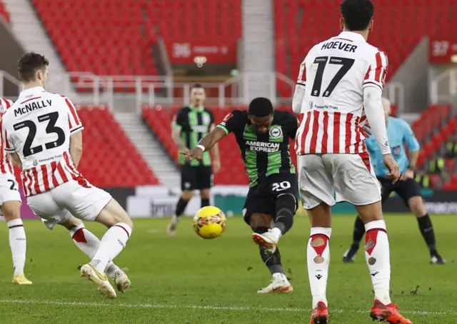 Pervis Estupinan shoots as Stoke players look on