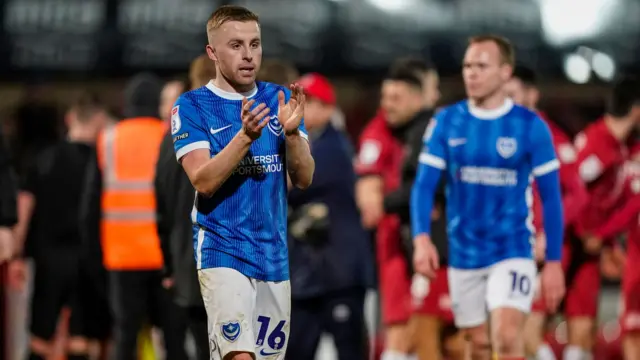 Portsmouth players walk off after their defeat by Cheltenham