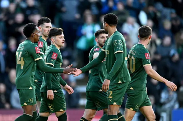 Luke Cundle of Plymouth Argyle (3L) celebrates scoring