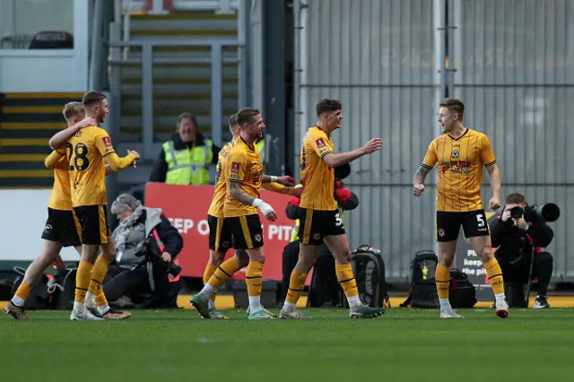 James Clarke of Newport County celebrates with teammates