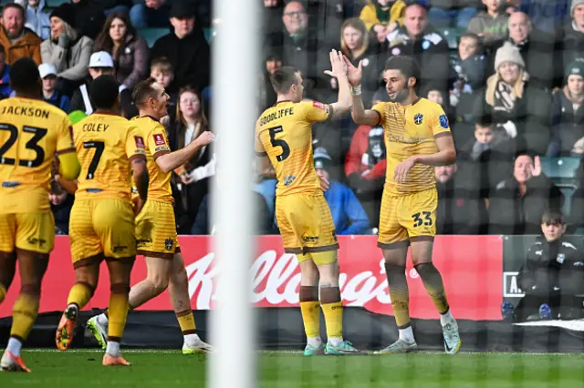 Lee Angol of Sutton United celebrates scoring his team's first goal