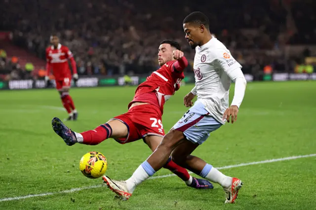 Leon Bailey of Aston Villa is challenged by Sam Greenwood