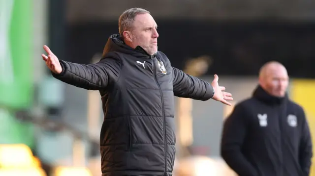 Port Vale manager Andy Crosby waves his arms in anger against Charlton