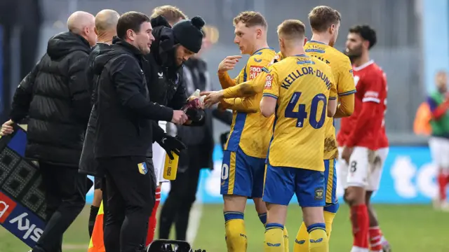 Mansfield boss Nigel Clough passes on messages to his players