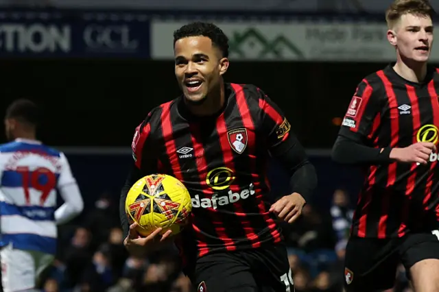 Justin Kluivert celebrates after scoring, Kluivert holds the ball while celebrating