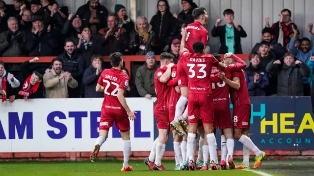 Cheltenham players celebrate scoring against Portsmouth