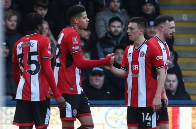 Sheffield United's William Osula celebrates scoring their first goal with Luke Thomas and Andre Brooks