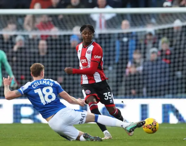 Sheffield United's Andre Brooks looks on as Gillingham's Ethan Coleman slide tackles