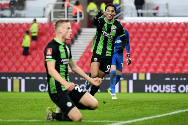 Joao Pedro of Brighton & Hove Albion celebrates scoring (background)