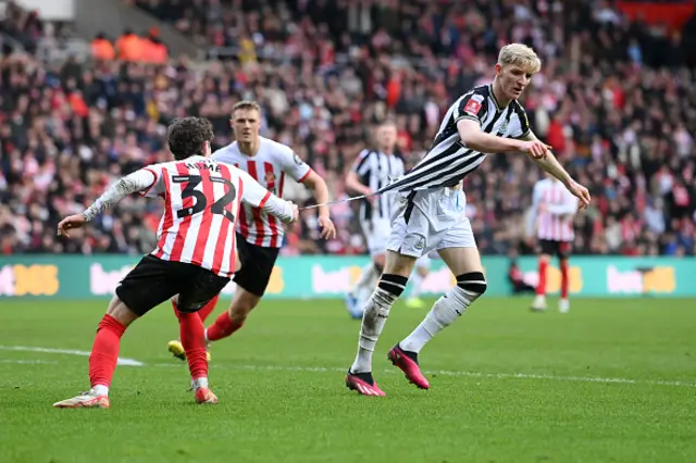 Trai Hume of Sunderland pulls the shirt of Anthony Gordon