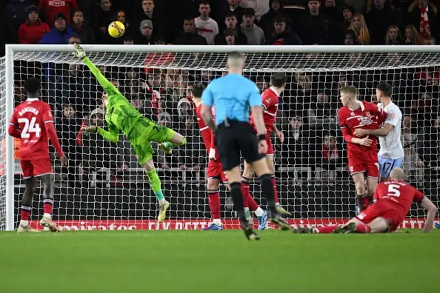 Tom Glover jumps to make a save