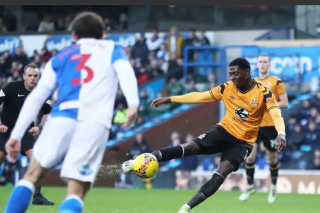 Cambridge United's Sullay Kaikai takes a shot, as a Blackburn player looks on