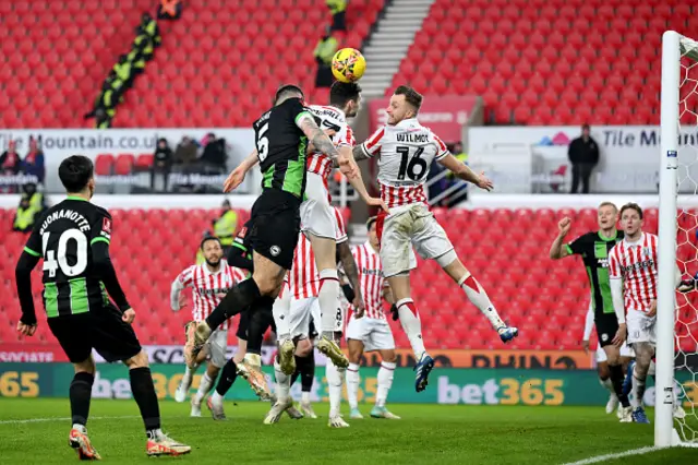 Lewis Dunk of Brighton & Hove Albion competes back post for the ball