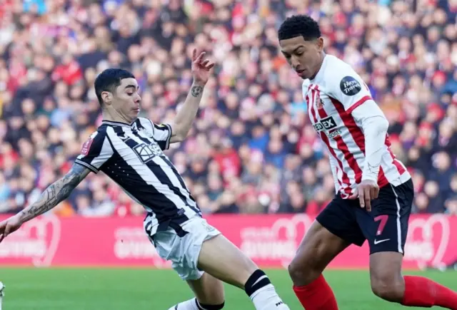 Almiron competes with jobe Belligham for the ball