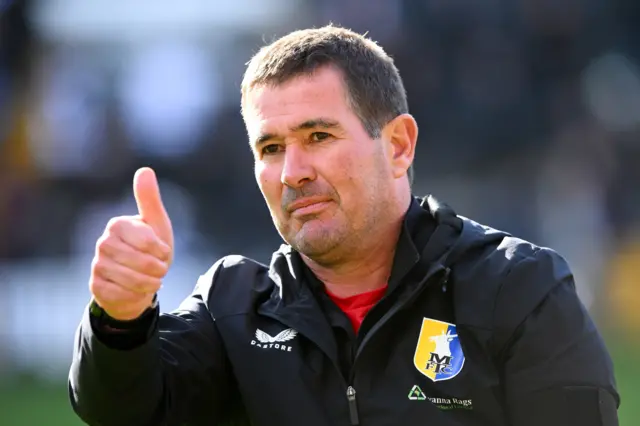 Mansfield Town manager Nigel Clough gives the thumbs up to fans