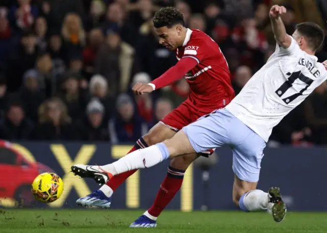 Morgan Rogers takes a shot as Lenglet attmepts to block the ball