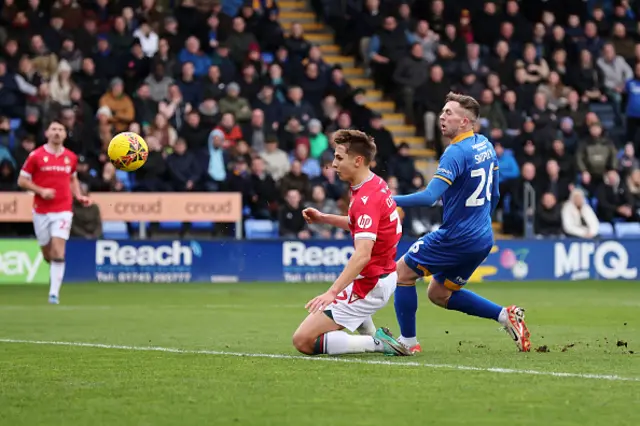 Jordan Shipley of Shrewsbury Town shoots on goal ahead of Max Cleworth