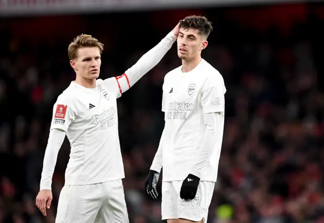 Martin Odegaard of Arsenal interacts with teammate Kai Havertz