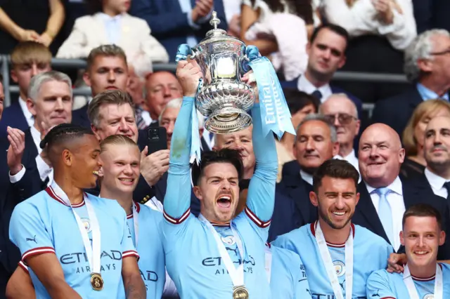 Jack Grealish of Manchester City lifts the Emirates FA Cup trophy