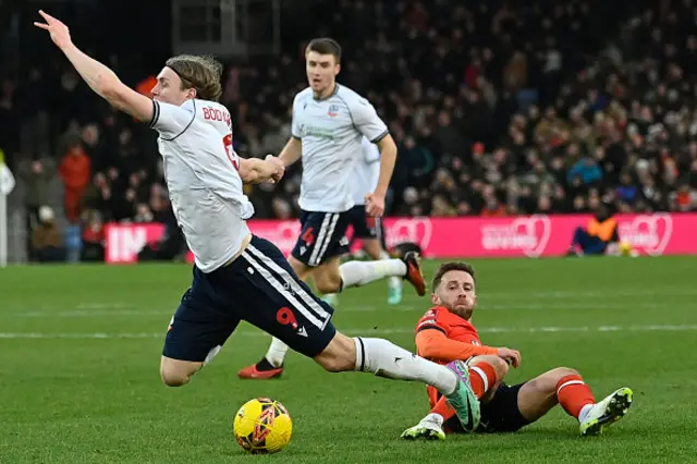 Jordan Clark fouls Bolton Wanderers' Icelandic striker Jon Daoi Boovarsson