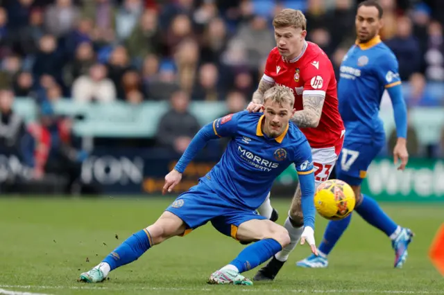 Wrexham's James McClean (R) challenges Taylor Perry of Shrewsbury