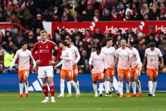 Joe Worral looks on as Blackpool players celebrate their second goal