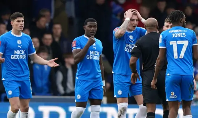 Peterborough United react to referee Sam Allison after Leeds United's Ethan Ampadu scores