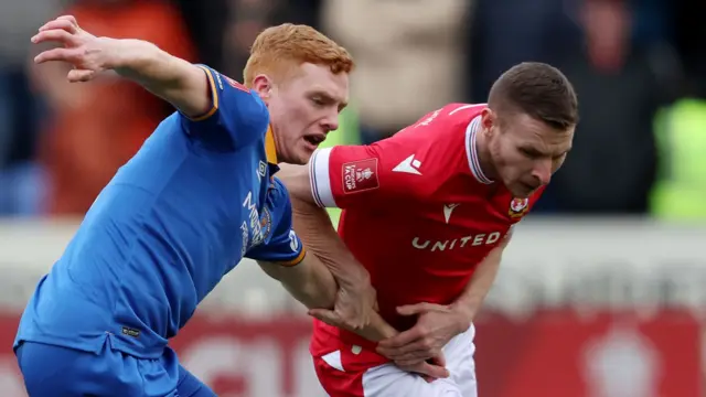 Paul Mullin (R) of Wrexham and Morgan Feeney of Shrewsbury Town