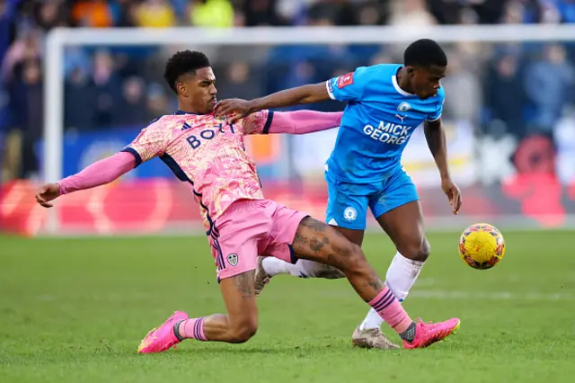 Kwame Poku of Peterborough United (R) and Junior Firpo