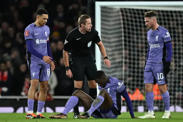 English referee John Brooks checks on Liverpool's French defender Ibrahima Konate