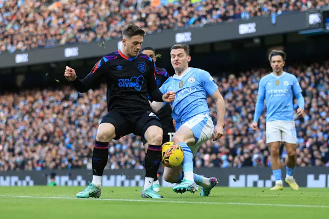 Sergio Gomez of Manchester City battles with Ben Wiles